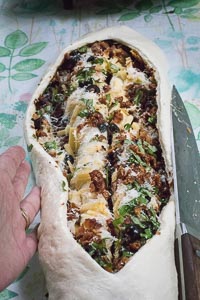 Sliced down the middle, stopping one inch from each end_