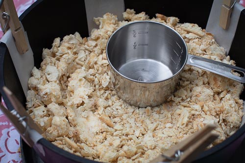 A one cup measure helps to press cracker crust into bottom of oven